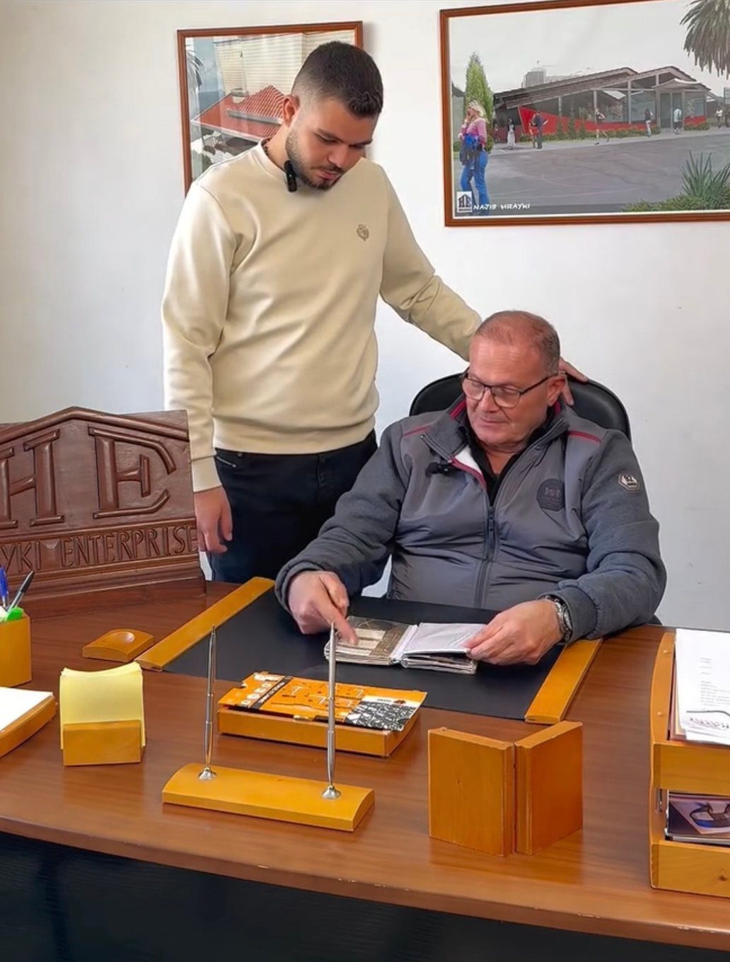 The Hrayki family reviewing project drawings in the office