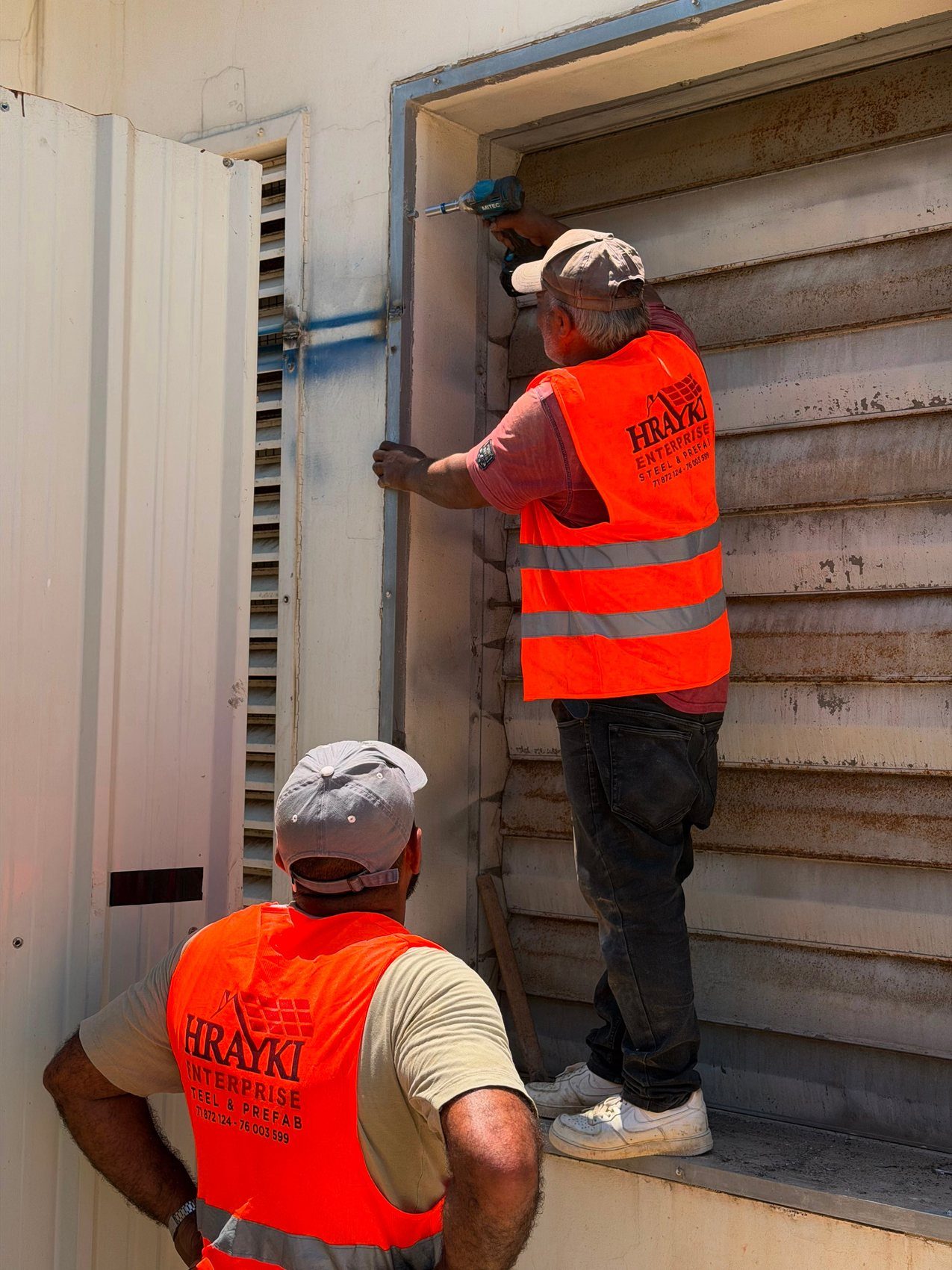 Hrayki Enterprise crew fitting a door on a prefabricated unit