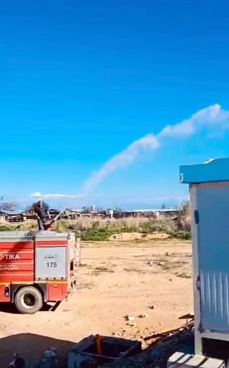 Fire truck spraying a prefabricated unit during leak testing