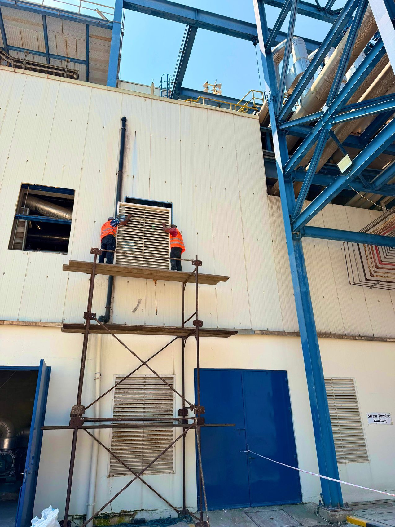 Hrayki Enterprise crew installing an industrial ventilation panel